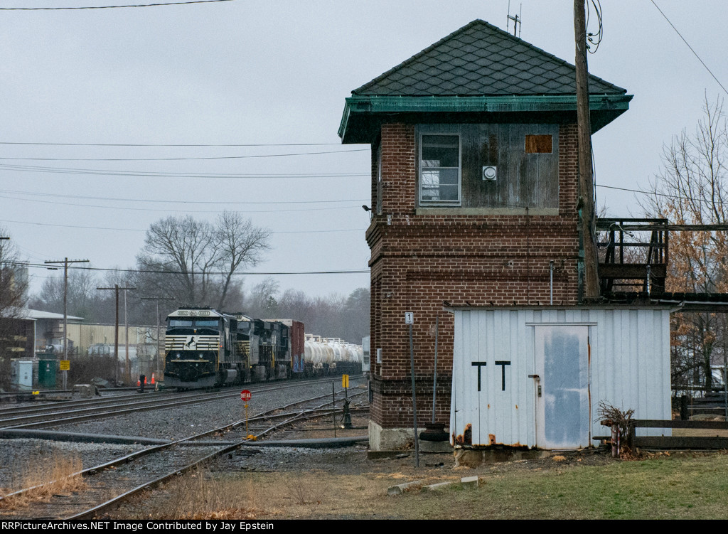 An eastbound sits just past the station platform 